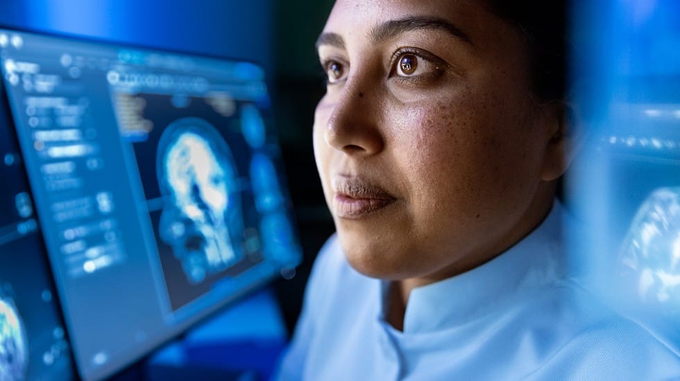 A female radiologist looking at a screen using AI