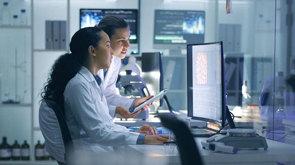 Download image (.jpg) (opens in a new window) Two doctors reviewing mammogram case