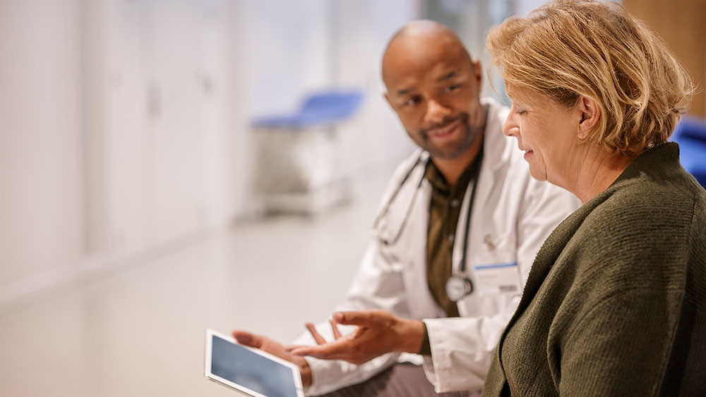 Download image (.jpg) (opens in a new window) Two doctors reviewing mammogram case
